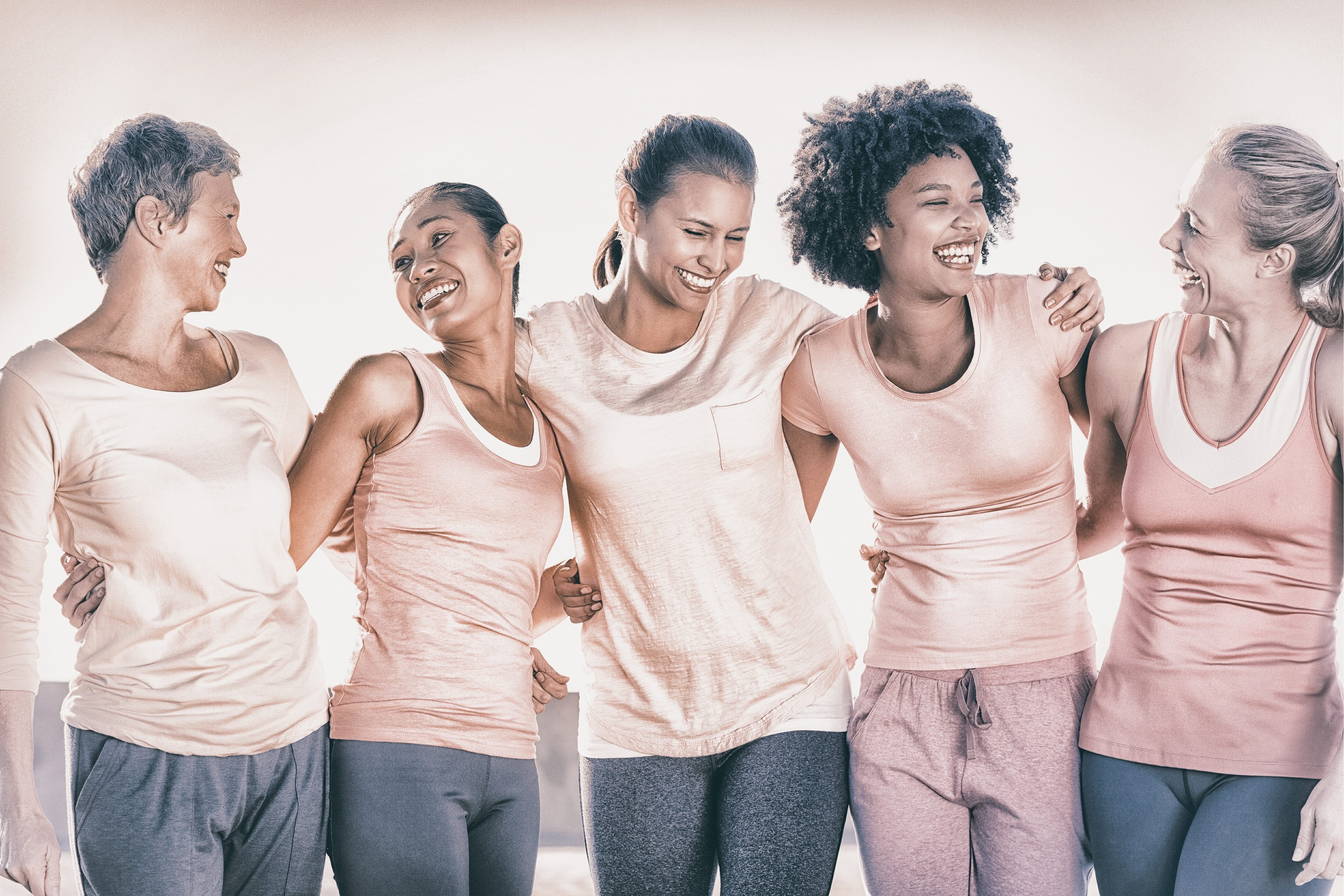 Five women with arms around each other