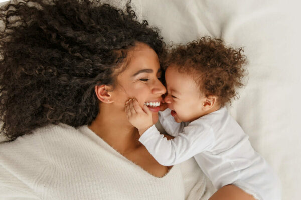 Woman laying in bed with child