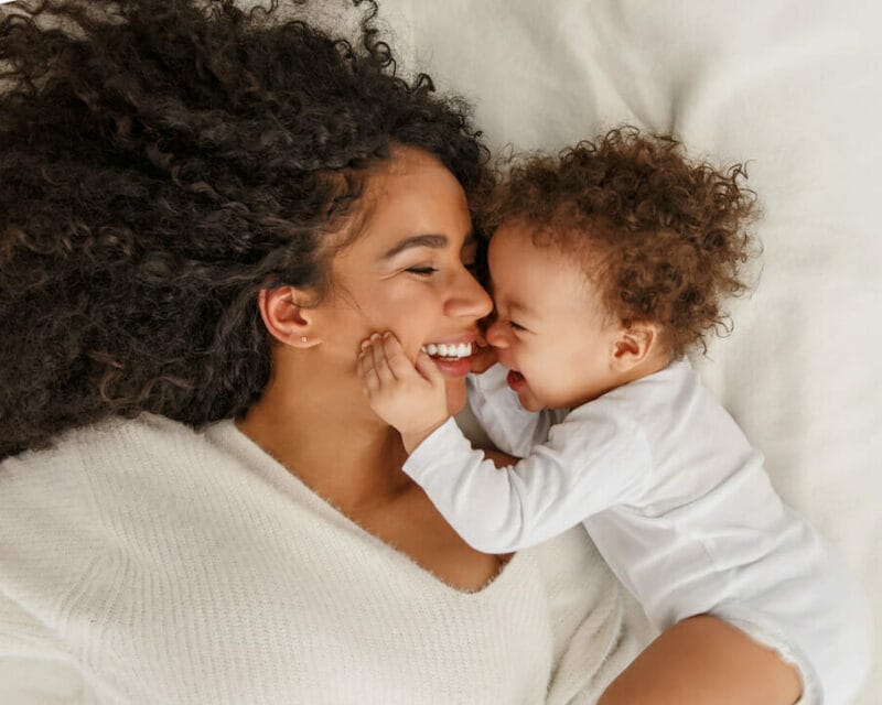 Woman laying in bed with child