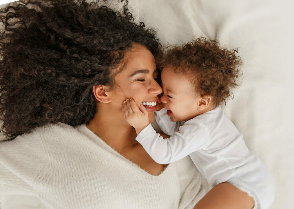 Woman laying in bed with child